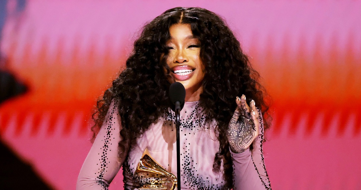 SZA Holds Phone as She Runs to Accept Grammy for Best R&B Song