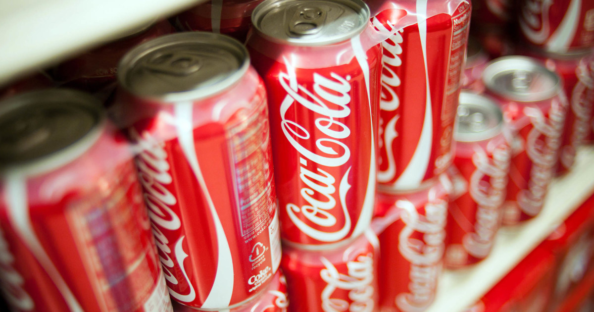 Stacked Coca-Cola cans with inspection magnifying glass