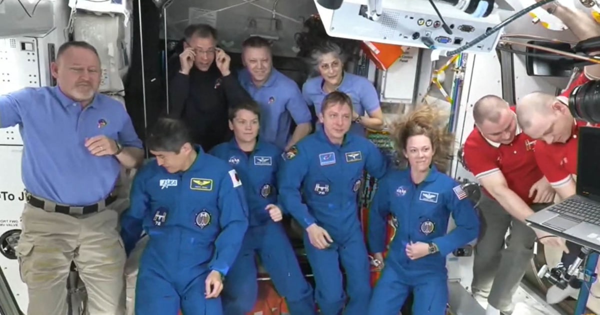 NASA’s stuck astronauts welcome their newly arrived replacements to the space station