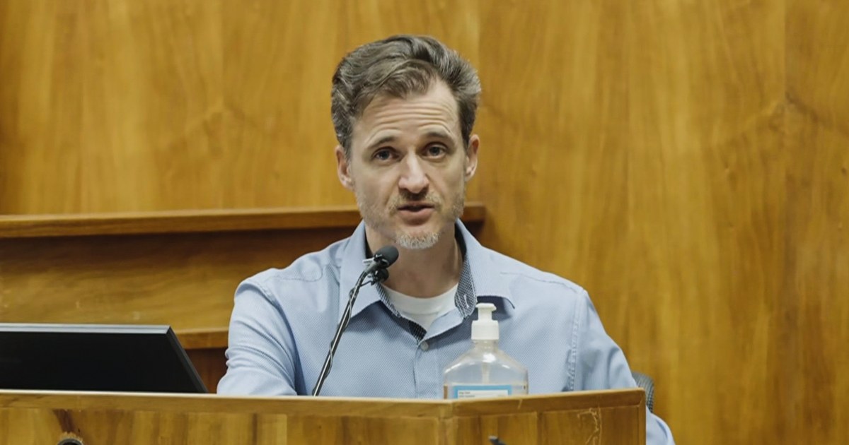 A Hawaii doctor charged with attempting to kill his wife during a hike on her birthday testified that he hit her in the head with a rock in an act of self-defense.